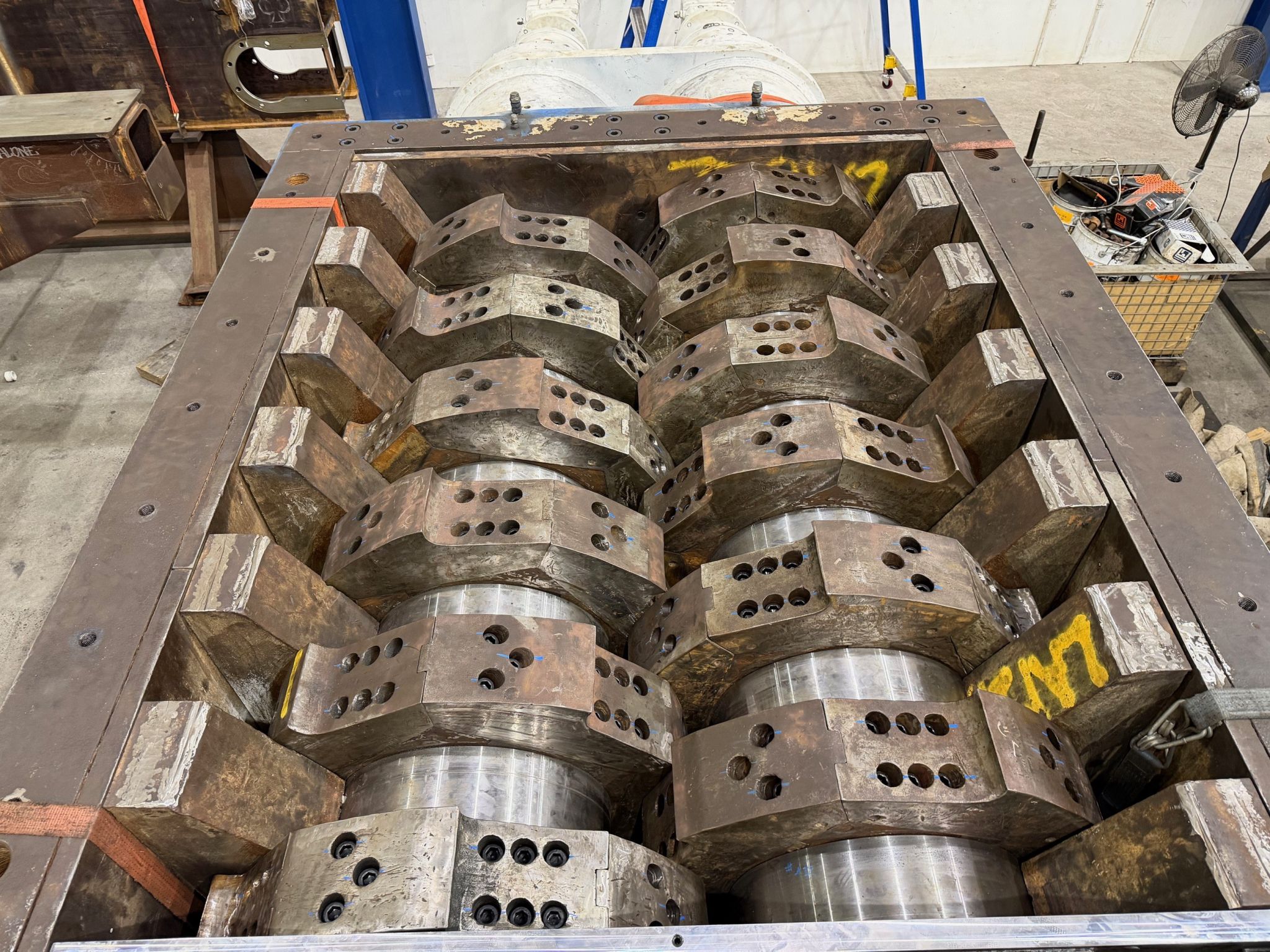 Worn and fused cutter discs on the shafts of the client shredder before refurbishment