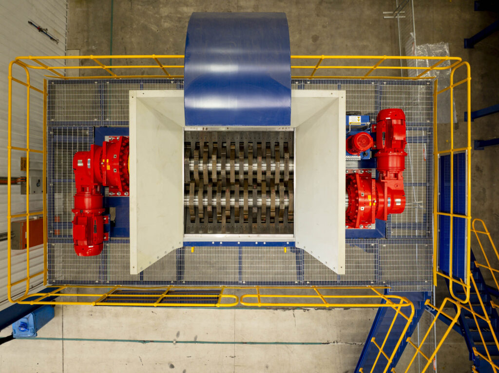 An Eilbeck primary shredder seen from above, with its cutters between two red gear motors